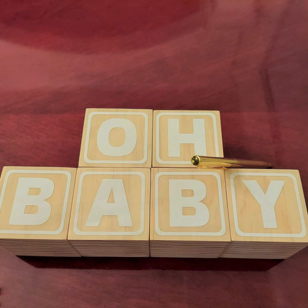 Have Baby Shower guests decorate wooden blocks with paint pens. 1
